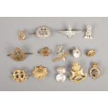 A quantity of military cap badges including The Rangers, The West Riding, Middlesex Regiment, etc.
