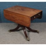 A Regency mahogany Pembroke table with single drawer. Raised on reeded splayed legs with brass