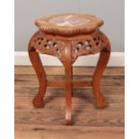 An oriental hardwood plant stand with inset marble top and carved floral decoration. Approx.