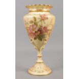 A Royal Worcester blushware vase of conical form raised on clawed foot, decorated with flowers.