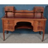 An Edwardian carved mahogany desk with leather inset top. Raised on slender tapering legs. (107cm