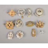 A quantity of military cap badges including Bedfordshire & Hertfordshire, Royal Corps of