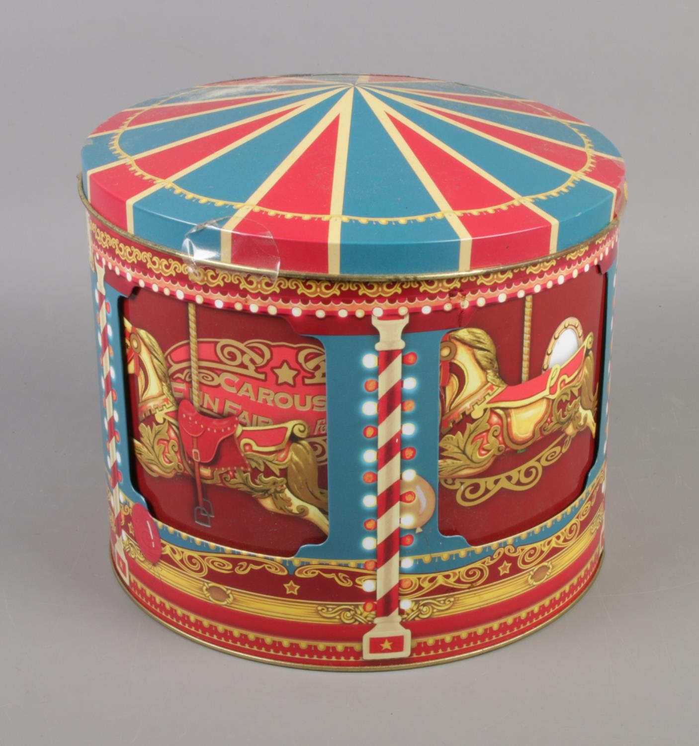 A modern musical rotating biscuit tin in the form of a carousel. Working.