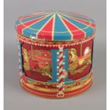 A modern musical rotating biscuit tin in the form of a carousel. Working.