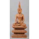 A carved wooden figure of a seated Buddha. 31.5cm.