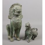 A bronze seated figure of a Foo dog along with a similar model of a Qilin. Foo dog 26cm.