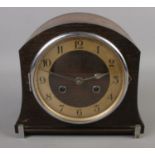 An oak dome shape mantel clock. Chiming on coil gong with key and pendulum.