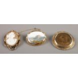 A Meissen hand painted brooch, together with a Victorian mourning brooch and cameo brooch.