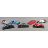 Seven Burago model vehicles, some on plinths. To include 1965 Shelby Cobra, 1957 Chevrolet