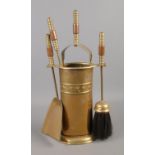 A brass fireplace companion set.