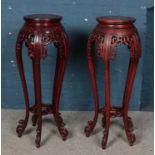 A pair of Chinese hardwood plant stands. Damage to decoration on one.