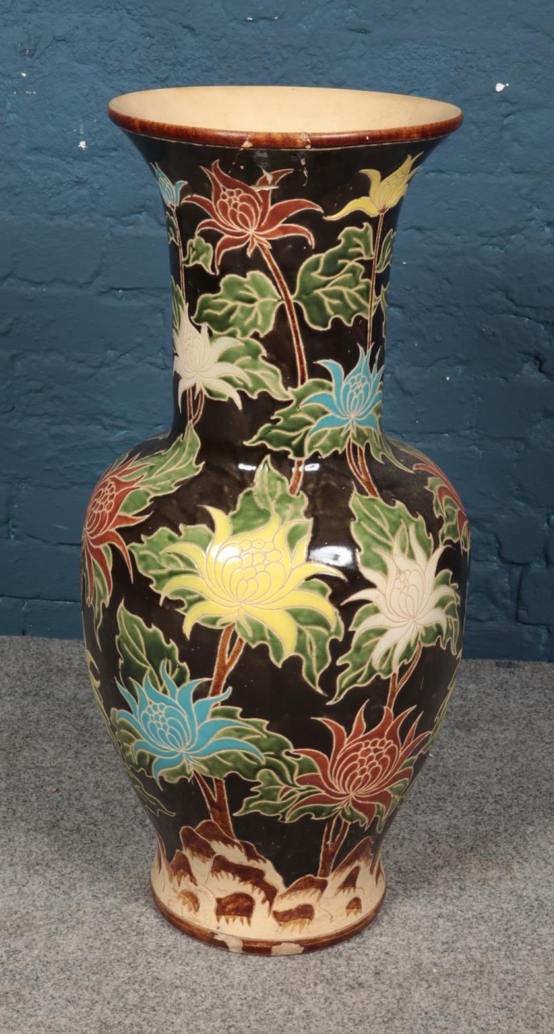 A large floor vase decorated with painted floral decoration. Height 83cm.