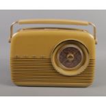A Bush 'Antique' radio in cream. Power cord missing.