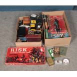 Two boxes of miscellaneous to include board games such as Risk, assorted Cricket books and boxed