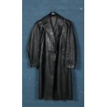 A black leather German full length coat, with fleece lining and bearing Swastika badge to inside