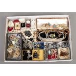 A tray of costume jewellery, to include mink brooches, statement earrings and beaded necklaces.