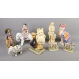 A quantity of ceramic figures including pair of zebras, candlestick modelled as grotesque fish,