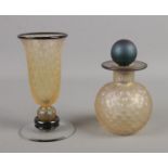 A matching iridescent glass scent bottle with stopper and vase. Signed to the base (indistinct)