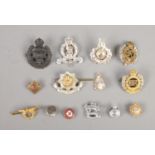 A quantity of military cap badges including Leeds Rifles, Cheshire, Royal Engineers, etc.