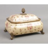 A Wong Lee 1895 hand painted porcelain and metal casket, with berry finial, raised on four