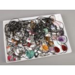 A large collection of pendant necklaces. Includes white metal and hardstone example.