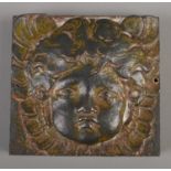 A late nineteenth/early twentieth century cast iron square plaque depicting a cherub. 9.5cm.