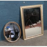 Two gilt framed mirrors including rectangular bevel example and oval floral example. Largest