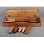 A pine brush box along with 13 assorted brushes.