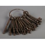 A metal ring of antique keys. Approximately 24.