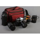 An Olympus OM10 SLR camera. With Olympus camera bag and equipment.