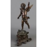 A bronze figure formed as a cherub. Raised on ornate base with mask decoration. (48cm)