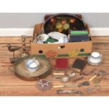A box of miscellaneous. Including paper mache tray, books, brass candlestick, flatware, etc.