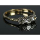 An 18ct Gold and three stone Diamond ring, approximately 0.78 pts. Size R. Total weight: 2.4g.