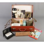 A suitcase of collectables. Includes Smiths bakelite clock, vintage photographs, Conway fountain