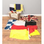 A wicker basket containing a quantity of linen flags. Mostly comprising of various signal flags