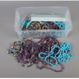 A box of gemstone chip necklaces and bracelets to include some amethyst examples.