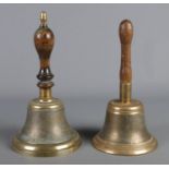 WITHDRAWN Two vintage brass school bells with turned wooden handles.