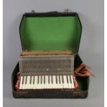 A cased Pietro accordion.
