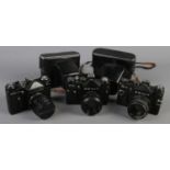 Three Zenit SLR cameras. Includes Zenit 12XP, Zenit TTL and Zenit E. Two with carry cases.