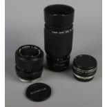 Three camera lenses. Including Olympus OM-System S Zuiko Auto-Zoom 35-70mm 1:4, Canon Zoom Lens FD