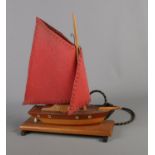 A novelty table lamp modelled as a sailboat.