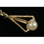 A 9ct gold and pearl droplet pendant on 9ct gold chain. 2.86g.