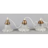 Three vintage light fittings, with frilled glass shades.