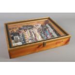 A tabletop bijouterie cabinet containing a large collection of costume jewellery including