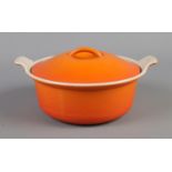 An orange Cousances casserole cooking pot.