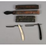Two cut throat razors, Bismarck and J.A Henckels, along with Crownshaw, Liverpool Razor strap.