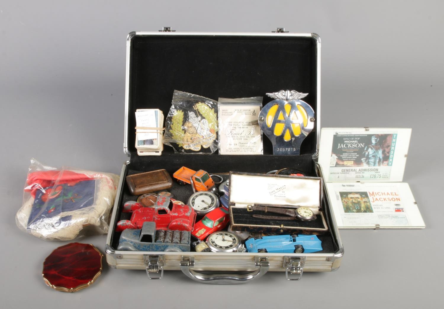 A hard shell suitcase containing a good quantity of collectables, to include AA car badge, Michael