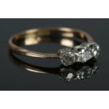A 18ct Gold and Platinum three stone Diamond ring. Size O. Total weight: 1.7g. Largest stone: 1/
