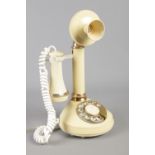 A cream Deco-Tel candlestick telephone, model no. AAI 4102.