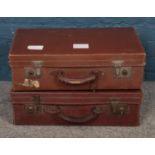 Two vintage luggage suitcases, both with keys.